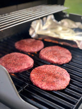 Load image into Gallery viewer, Beringer Family Farms 21 Day Dry Aged Angus Beef Collection. Photo of 4 1/3 pound hamburger patties on a grill.
