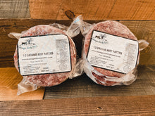 Load image into Gallery viewer, Beringer Family Farms 21 Day Dry Aged Angus Beef Collection. Photo of 4 1/3 pound hamburger patties frozen in vacuum sealed packaging.
